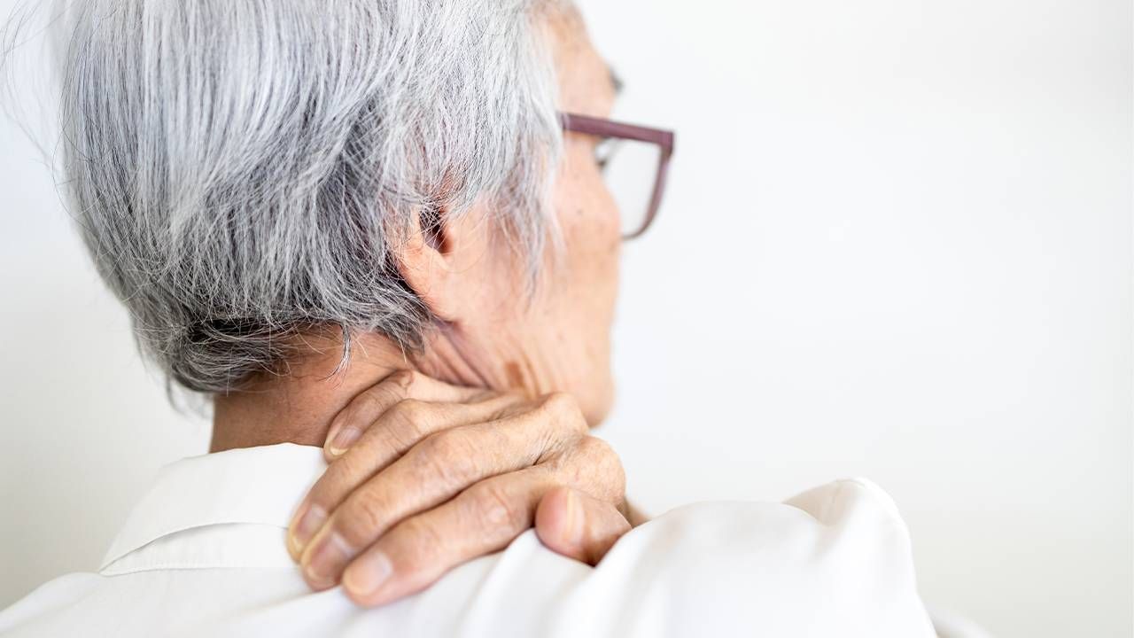 Woman massaging the back of her neck, how to manage chronic pain