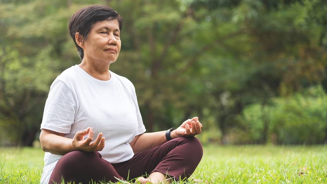 Older woman practicing yoga, treat your body kindly