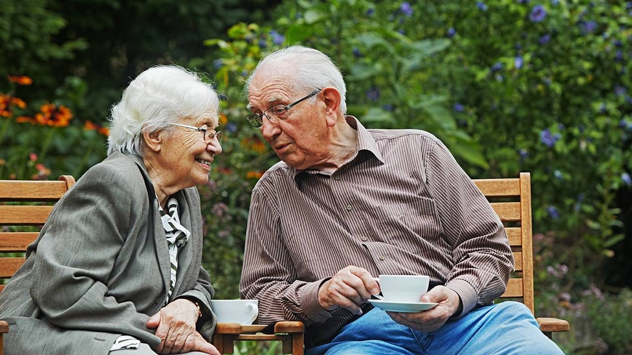 Older adults talking together in a garden, dignity and respect, Next Avenue, aging parents