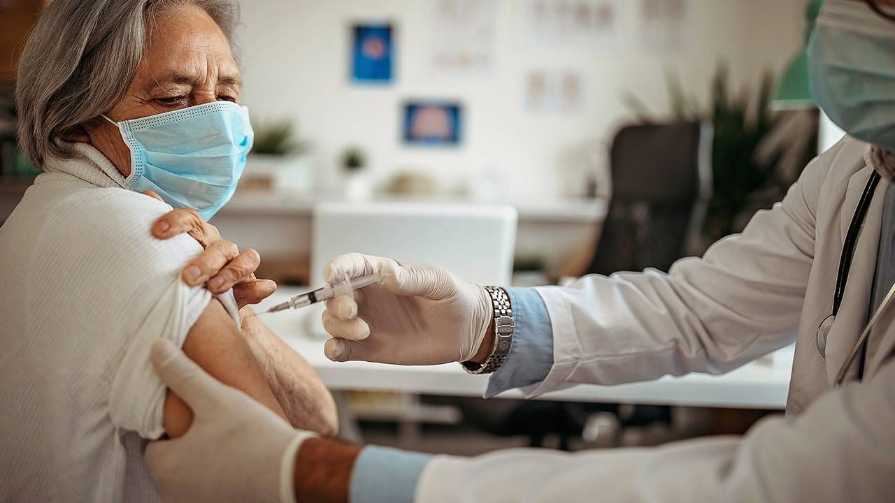 Woman getting vaccine shot from doctor, COVID-19 pandemic, Next Avenue