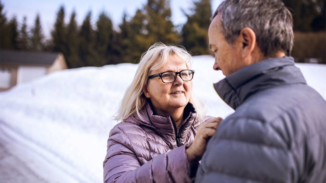 Woman helping man with his jacket, dementia, Mayo Clinic, Next Avenue