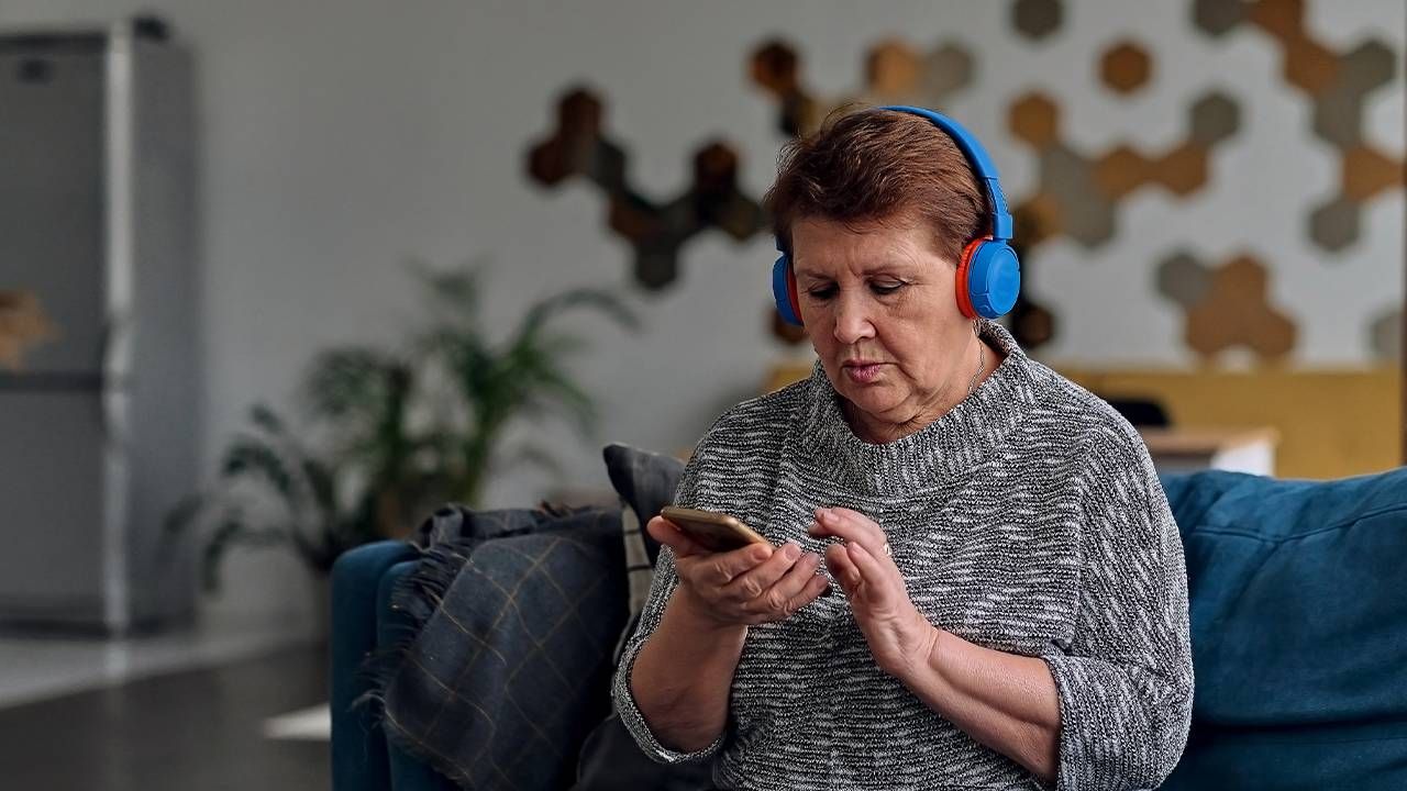 A woman listening to an audiobook with headphones, next avenue, audiobook, turn up audiobooks