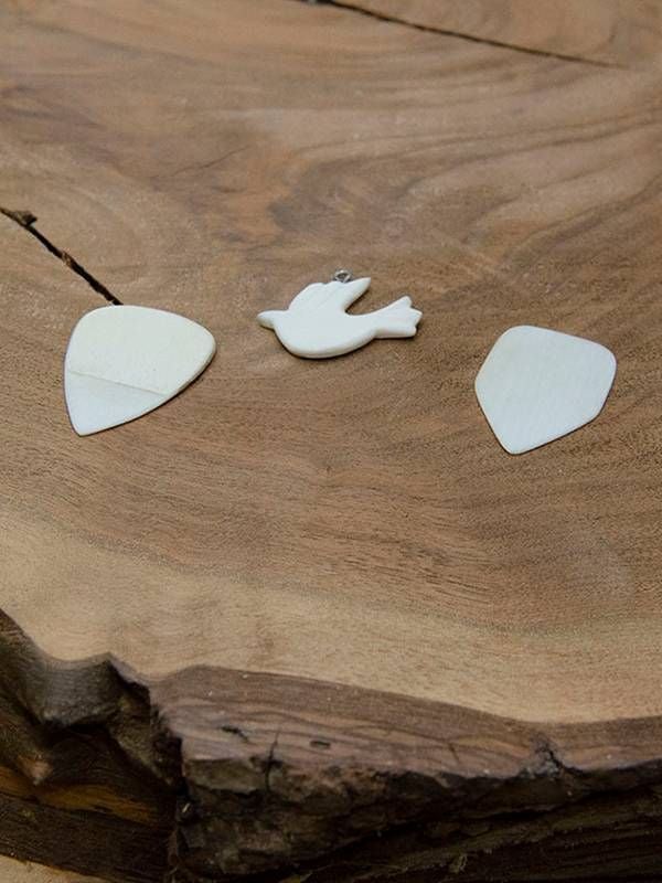 Guitar picks and a dove pendant made from ivory piano keys, restoration, Next Avenue