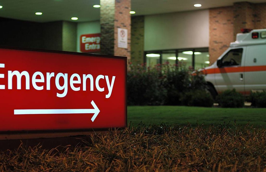 Hospital entrance with an ambulance, medical costs, Next Avenue