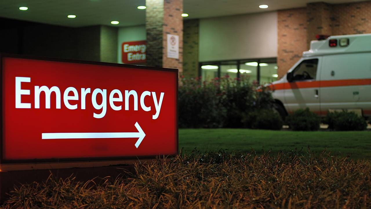 Hospital entrance with an ambulance, medical costs, Next Avenue