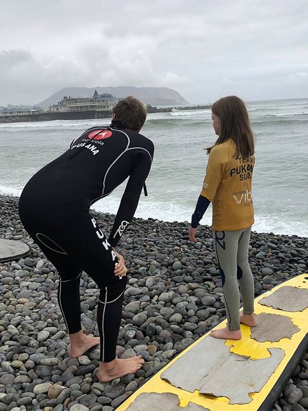 Father and daughter at the beach surfing, beginners, lifelong learning, Next Avenue