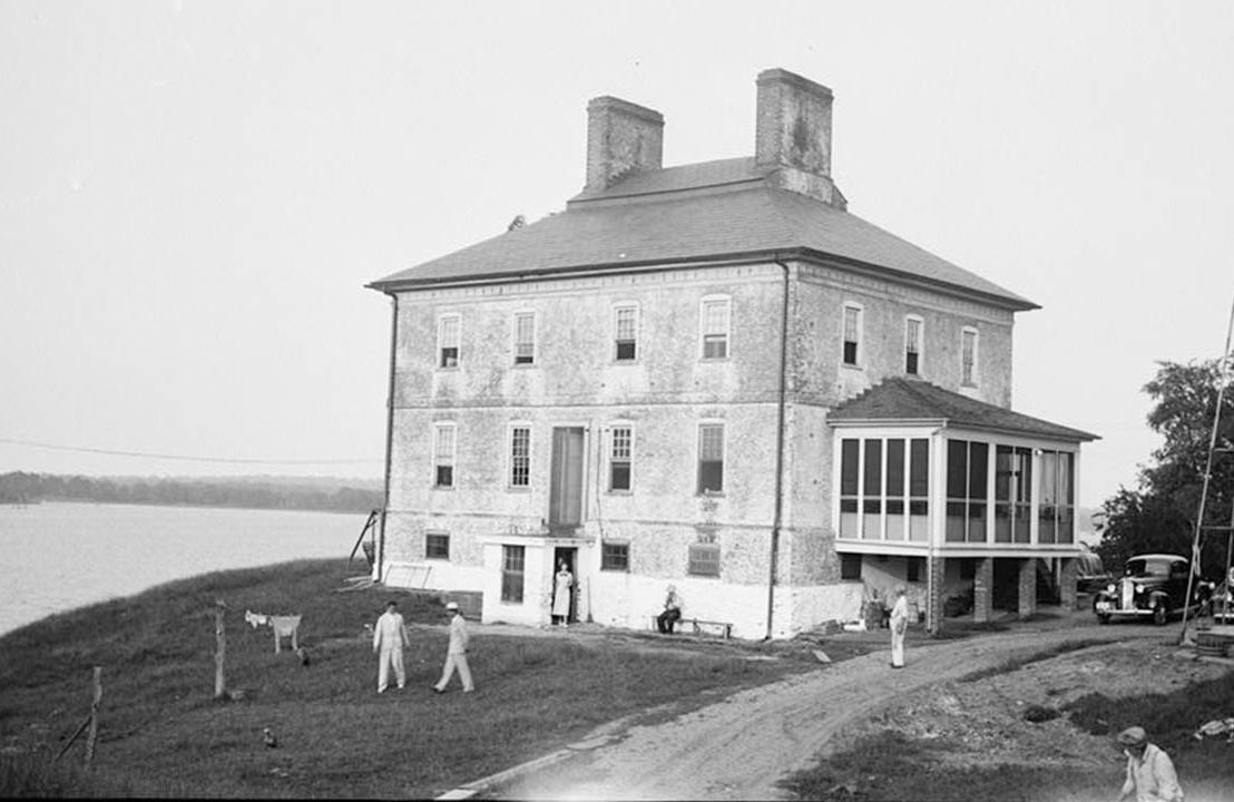 Old photograph of a group home on the water with people outside, history, Next Avenue