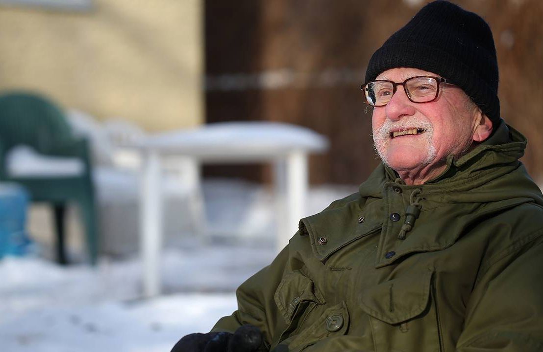 Older man sitting outside wearing warm jacket and hat, mild cognitive impairment, brain health, Next Avenue