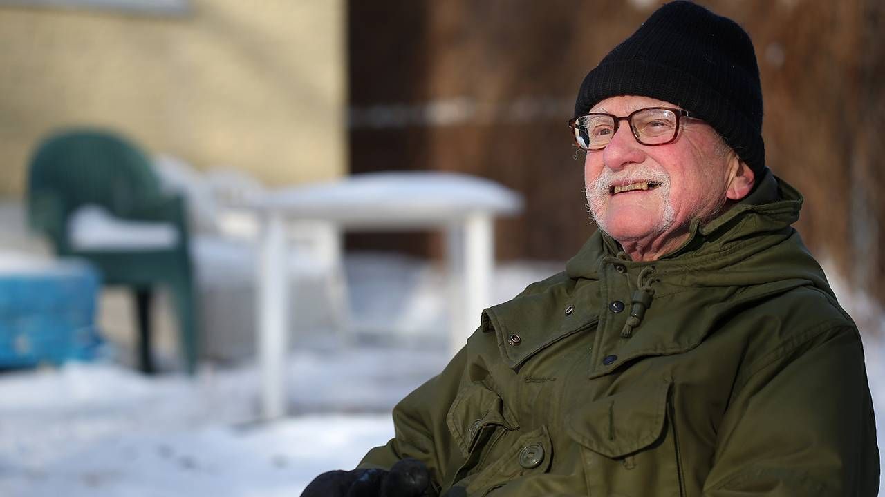 Older man sitting outside wearing warm jacket and hat, mild cognitive impairment, brain health, Next Avenue