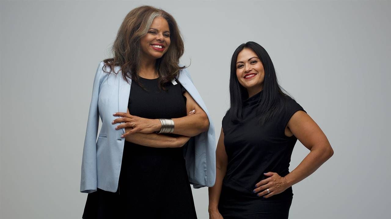 women over 50, Two women wearing black standing in their office, second act, Next Avenue