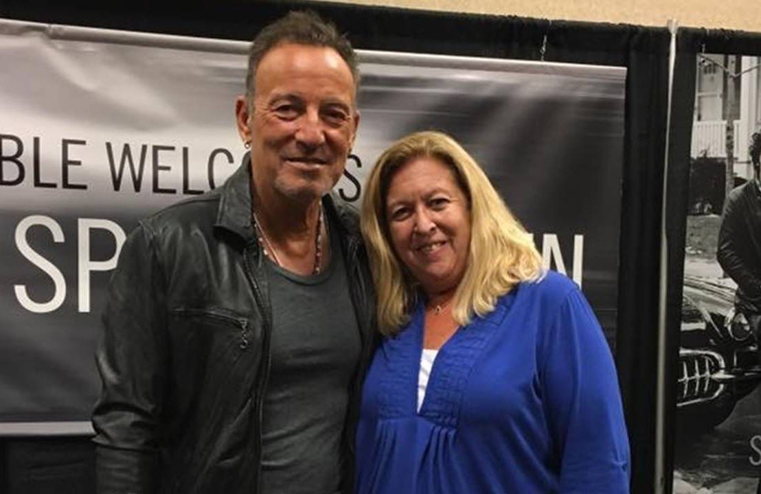 Middle aged woman posing backstage with musician Bruce Springsteen, vaccine, Next Avenue