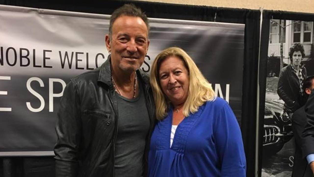 Middle aged woman posing backstage with musician Bruce Springsteen, vaccine, Next Avenue