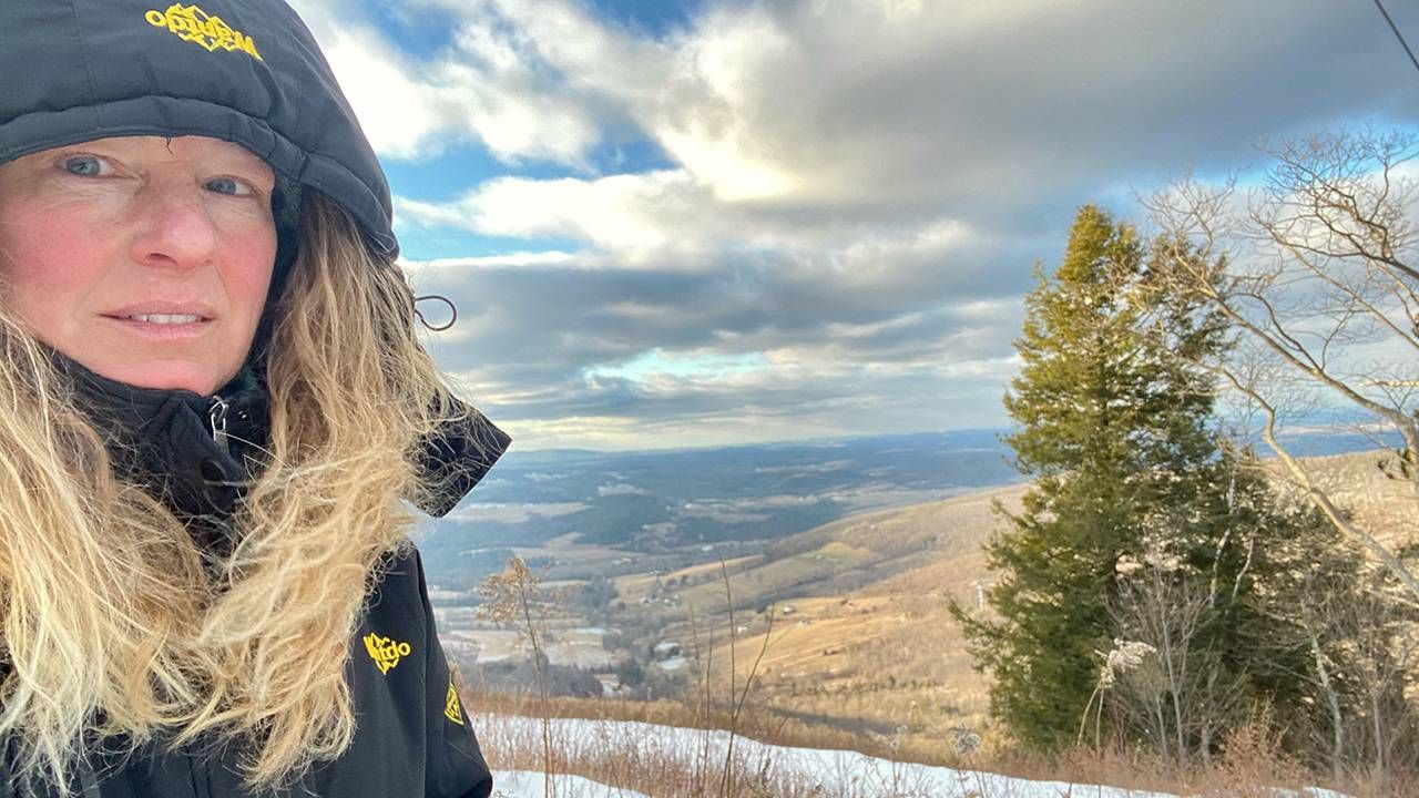 Middle-aged woman hiking on mountaintop, Next Avenue