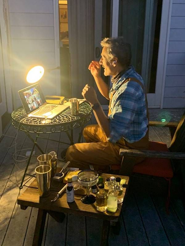 Older man sitting outside teaching a Zoom cocktail class, pandemic projects, pastimes, Next Avenue