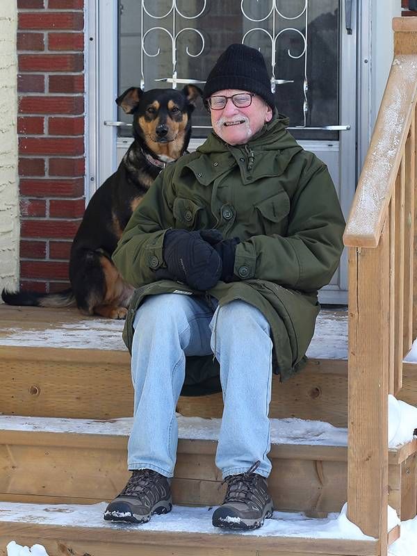 Older man and his dog sitting on his from stoop in the snow, mild cognitive impairment, brain health, Next Avenue