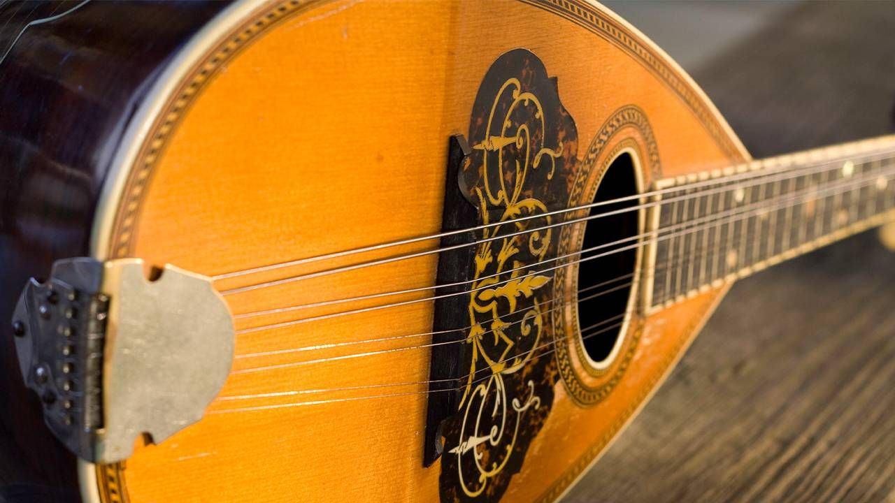 A vintage mandolin guitar with detailed inlay, apartment, Next Avenue