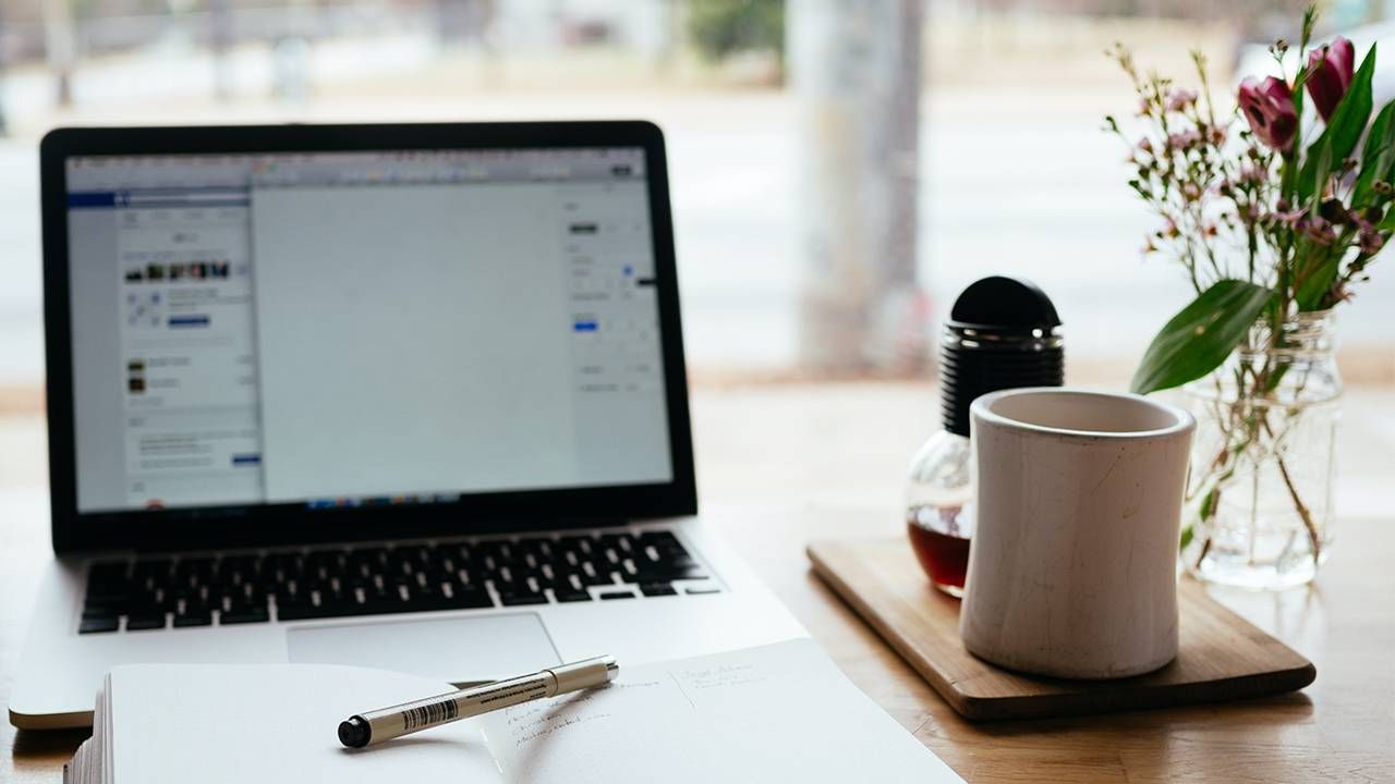 desk with laptop, calendar, coffee and vase of flowers, jobs, Next Avenue