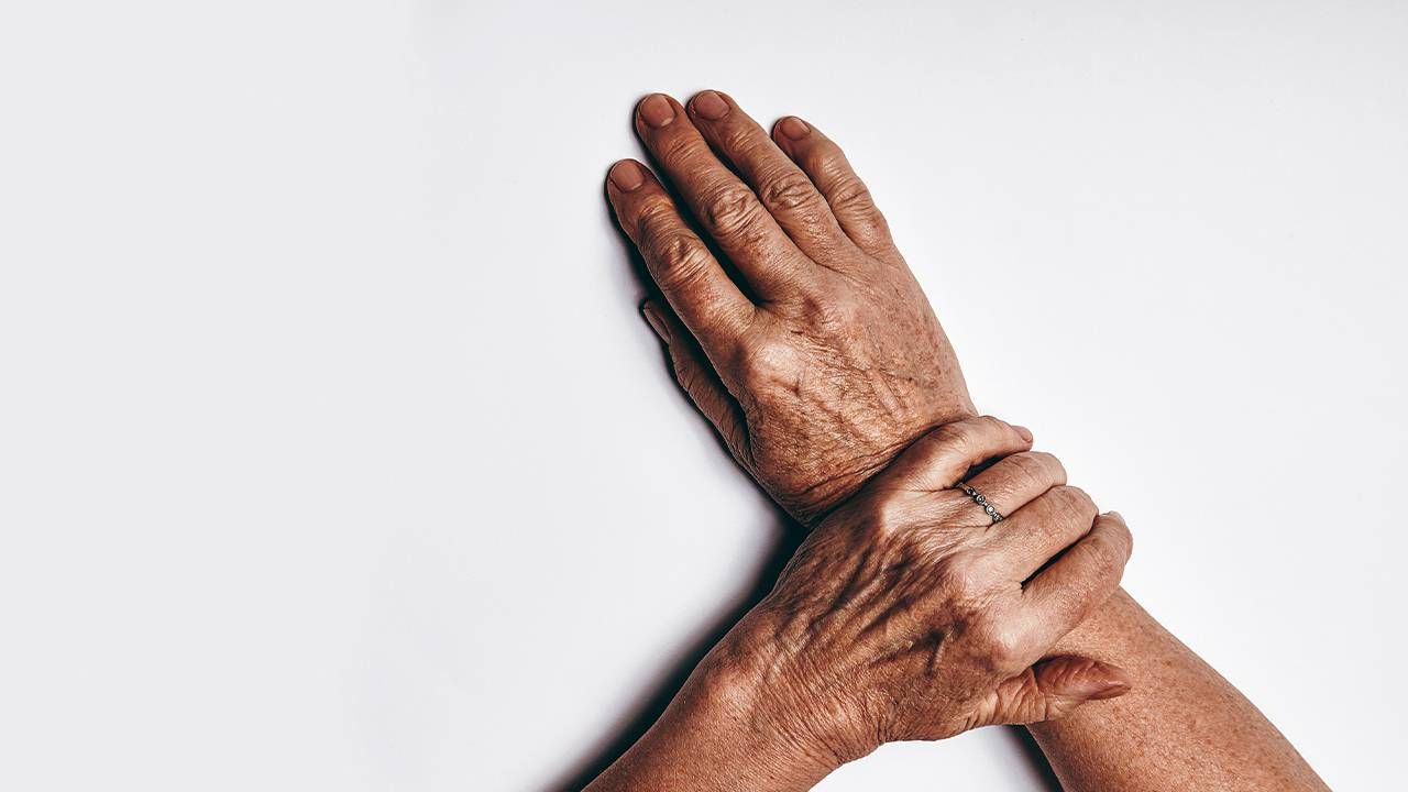 Close up of a middle aged person's hands with some skin spots. Next Avenue