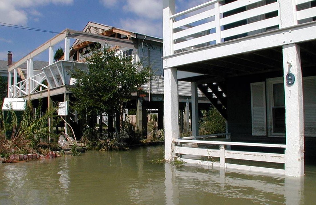 A row of houses on stilts that are heavily flooded, climate change, retirement, Next Avenue