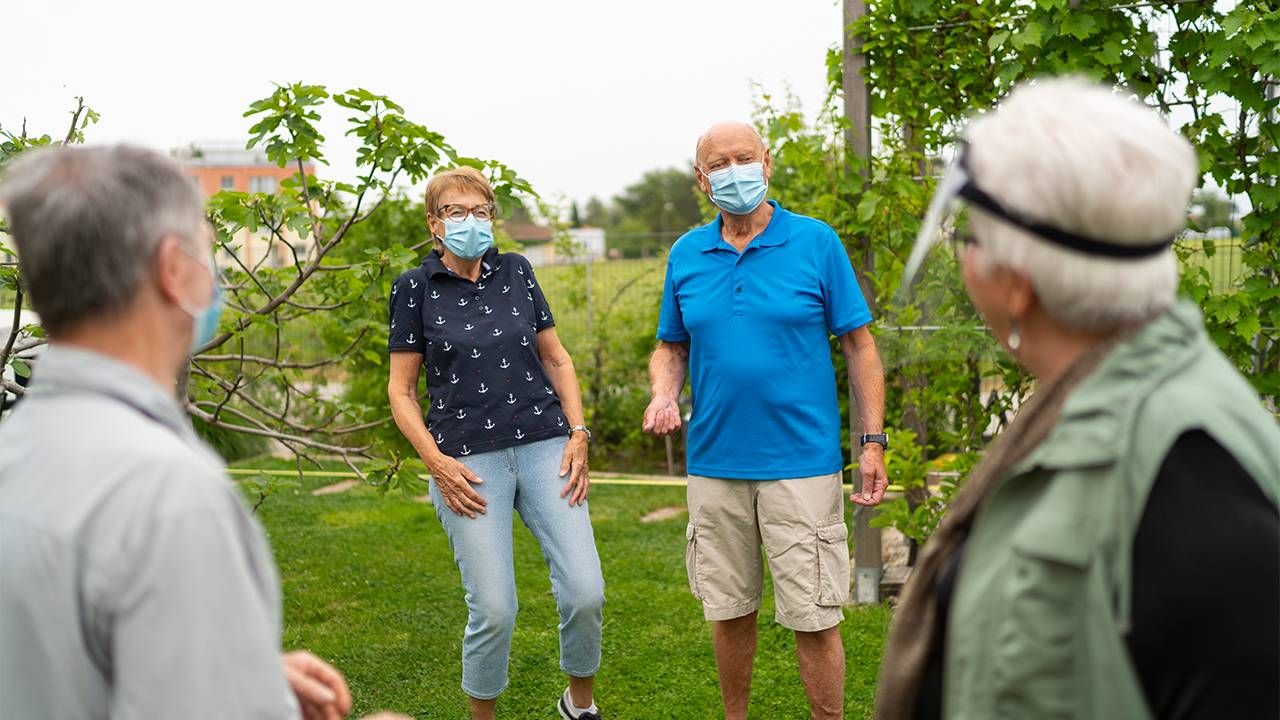 A group of older friends talking wearing face masks. Small talk, conversational skills, Next Avenue