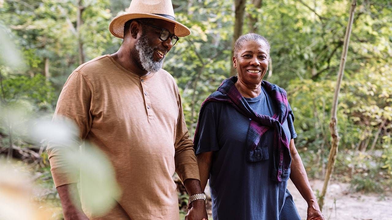 Older retired couple walking in the woods. Retirement, Next Avenue