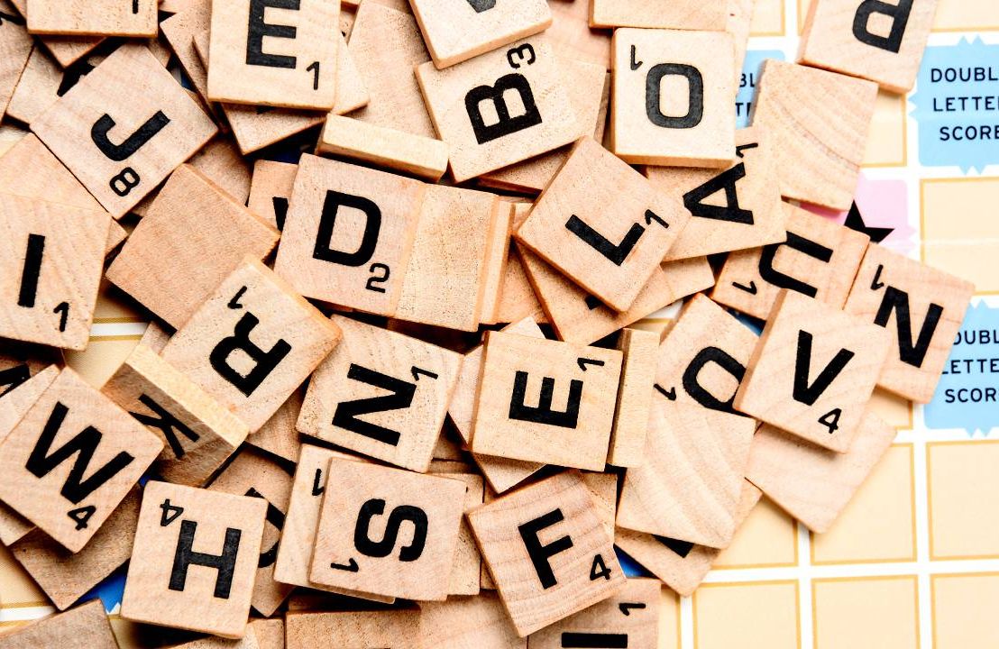 Close up of scrabble letters on top of a scrabble board, Next Avenue