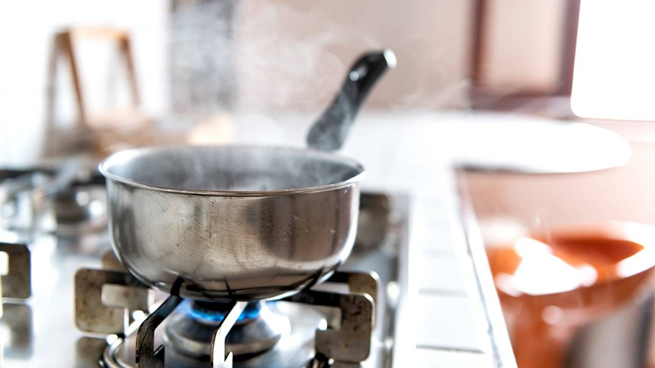 A pot of boiling broth on a stove in a sunny kitchen, caregiver, Next Avenue