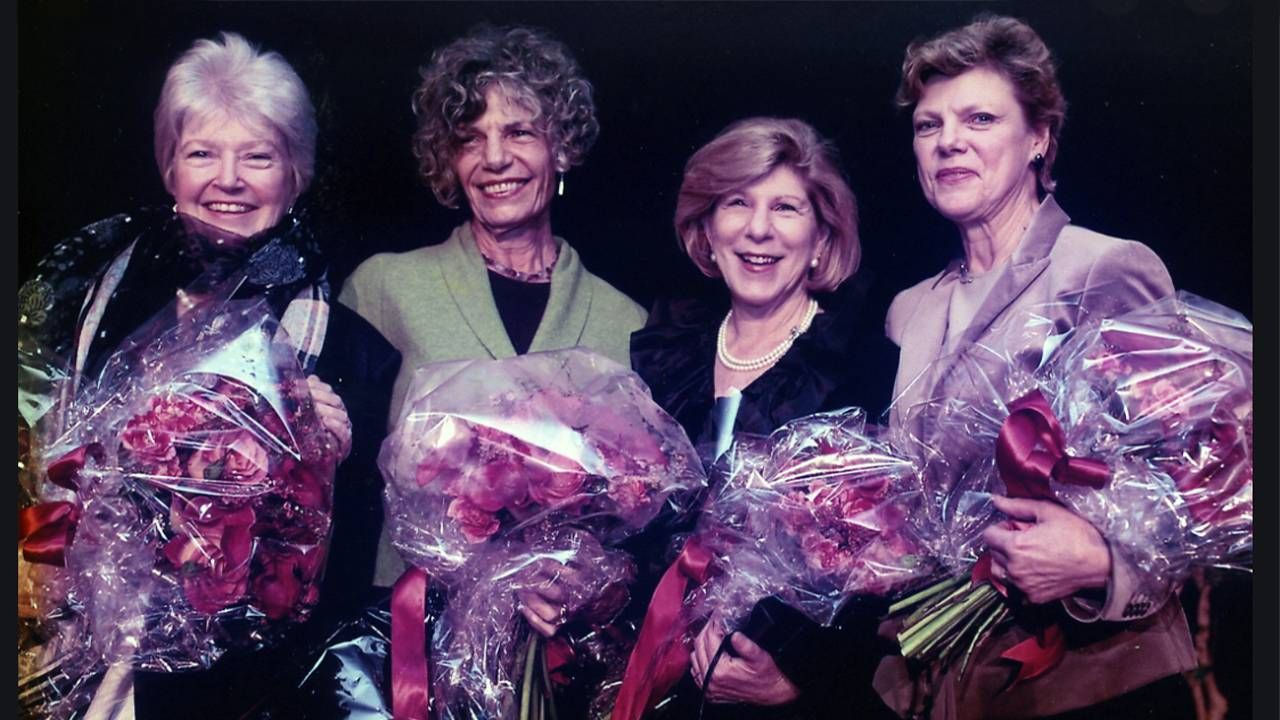 The four founding journalists standing side-by-side holding bouquets of roses. NPR, Founding Mothers, Next Avenue