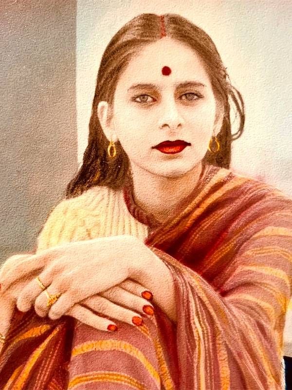 A young woman wearing a red sari and a traditional red bindi. Alka Joshi, Next Avenue, mother