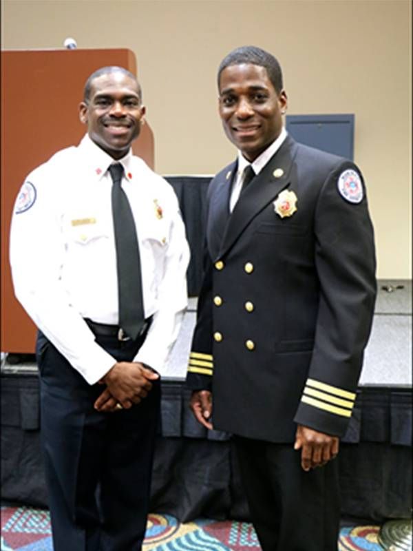 Two fire captains smiling in uniform. Racism, firefighters, Next Avenue