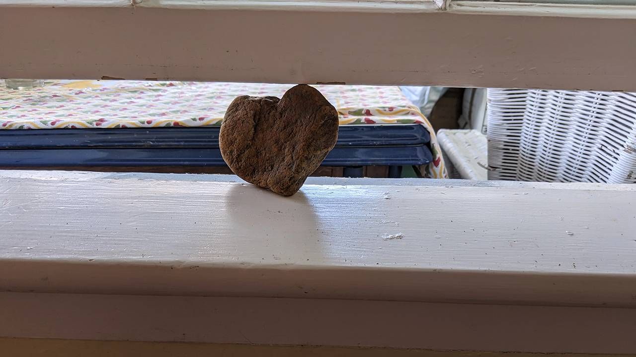 The author props her window open with a heart shaped rock, house, home, Next Avenue