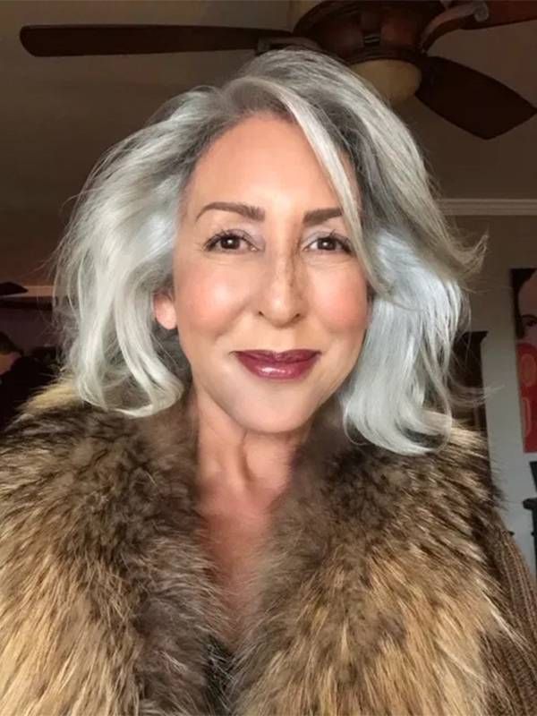 A woman with grey hair wearing a fur coat smiling. Older actors, Next Avenue