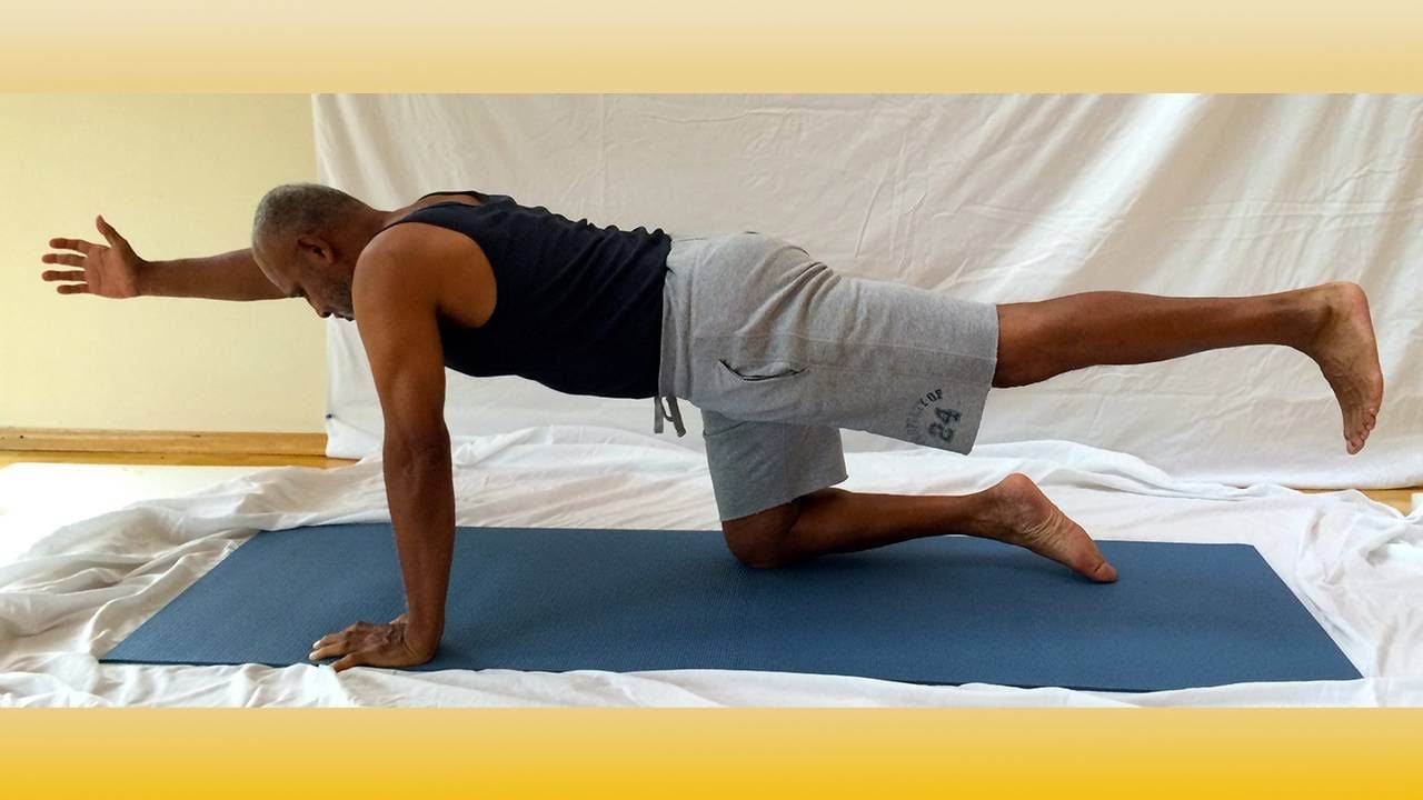 Man in prone position in spinal balance pose, yoga, Next Avenue