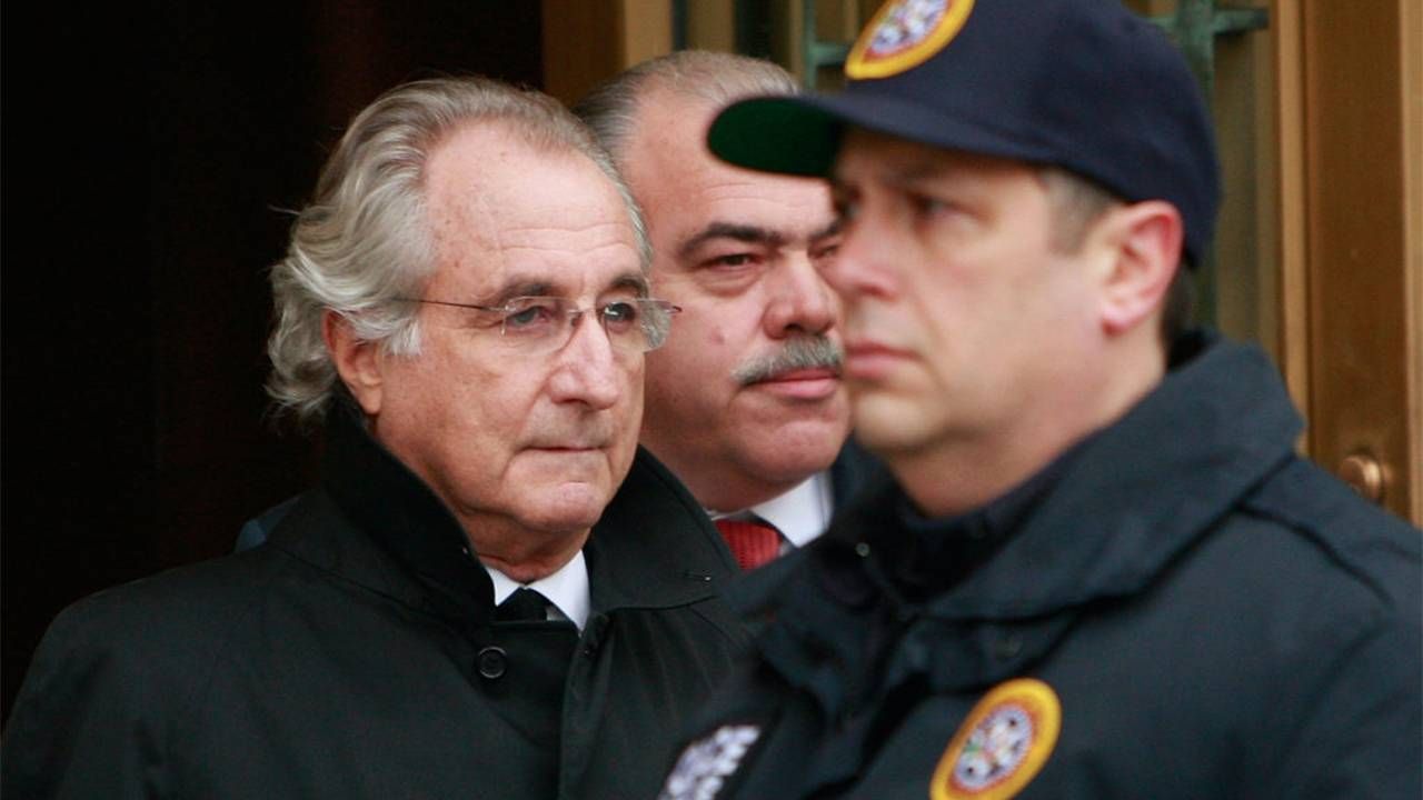 Bernie Madoff being escorted by two police officers. Madoff Talks, small investors, Next Avenue