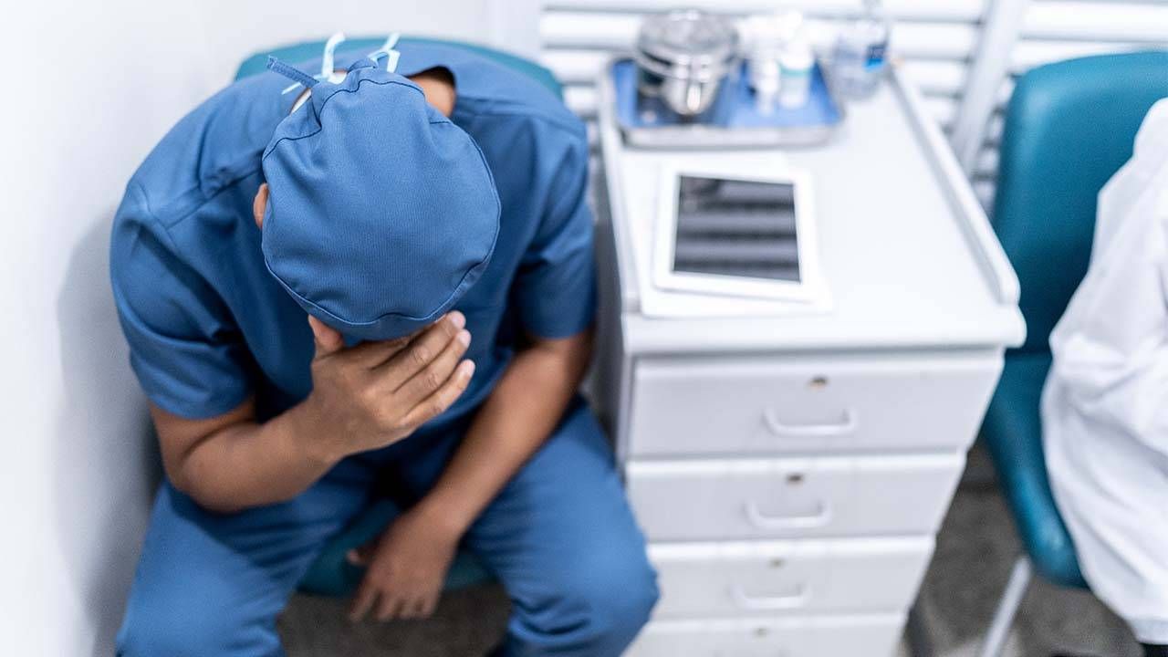 Doctor looking depressed with hands on head. Medicine, doctors, health care, Next Avenue