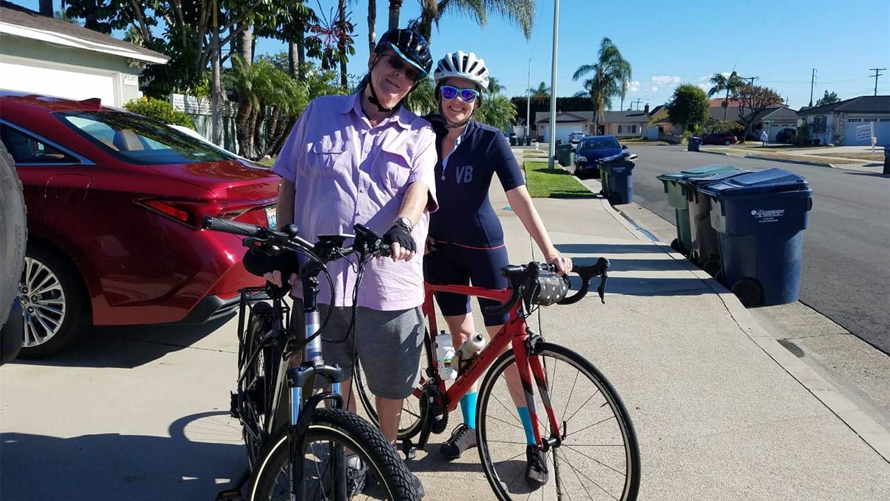 A father and daughter standing behind their electric bikes. E bikes, Next Avenue