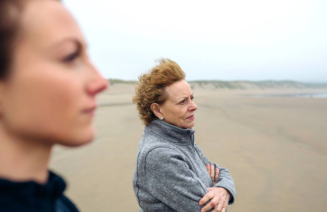 Two women walking on the beach looking serious. Estrangement, estranged, family, cutoff, Next Avenue