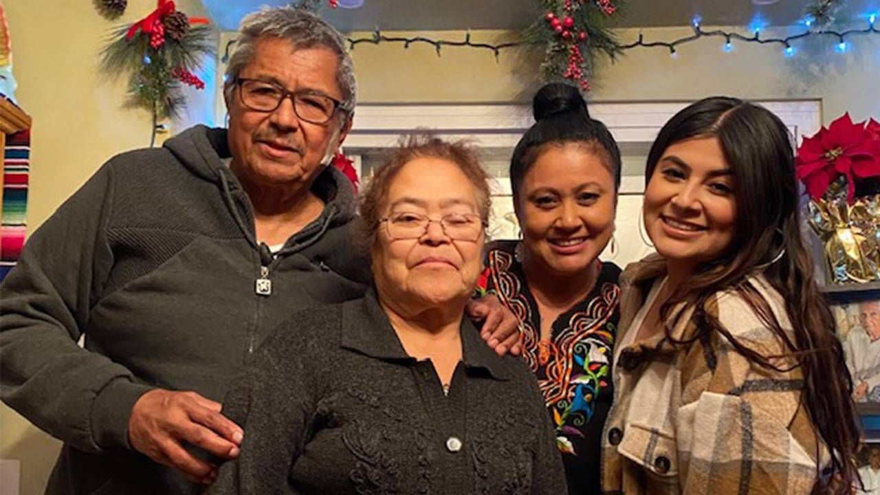 A multigenerational family smiling during the holiday season.