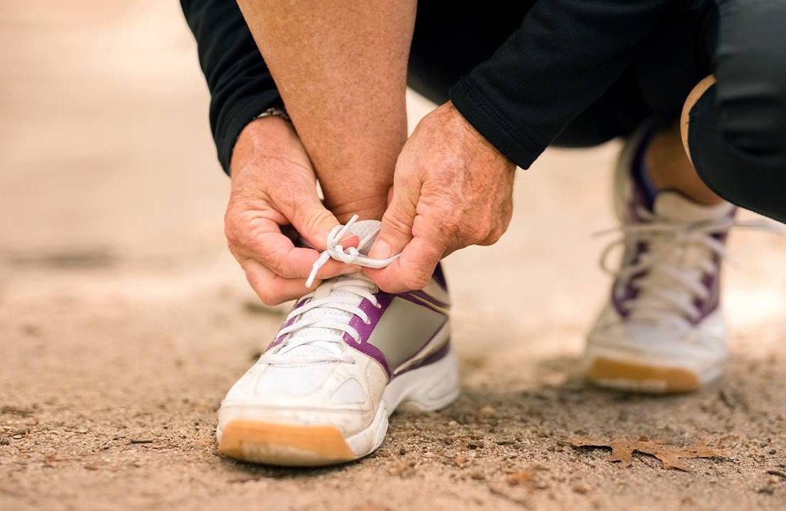 Closeup of a person tying their shoe laces. Foot health, feet health, Next Avenue