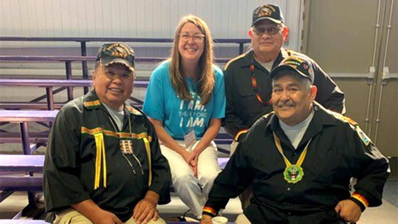 Four people sitting in the bleachers smiling. Community, dementia, Next Avenue