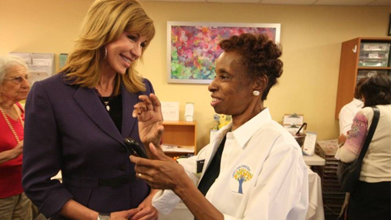 Leeza Gibbons smiling and talking with a volunteer caregiver. Caregiving, care, Leeza Gibbons, Next Avenue