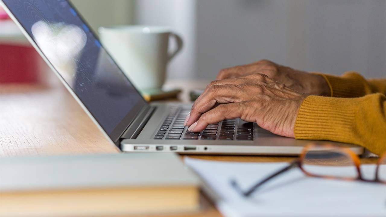 Close up of an older woman's hands typing on a keyboard. Letter of recommendation, recommendation letter, Next Avenue