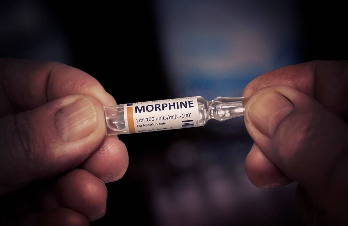 A vial of morphine held up close. Morphine, hospice, Next Avenue