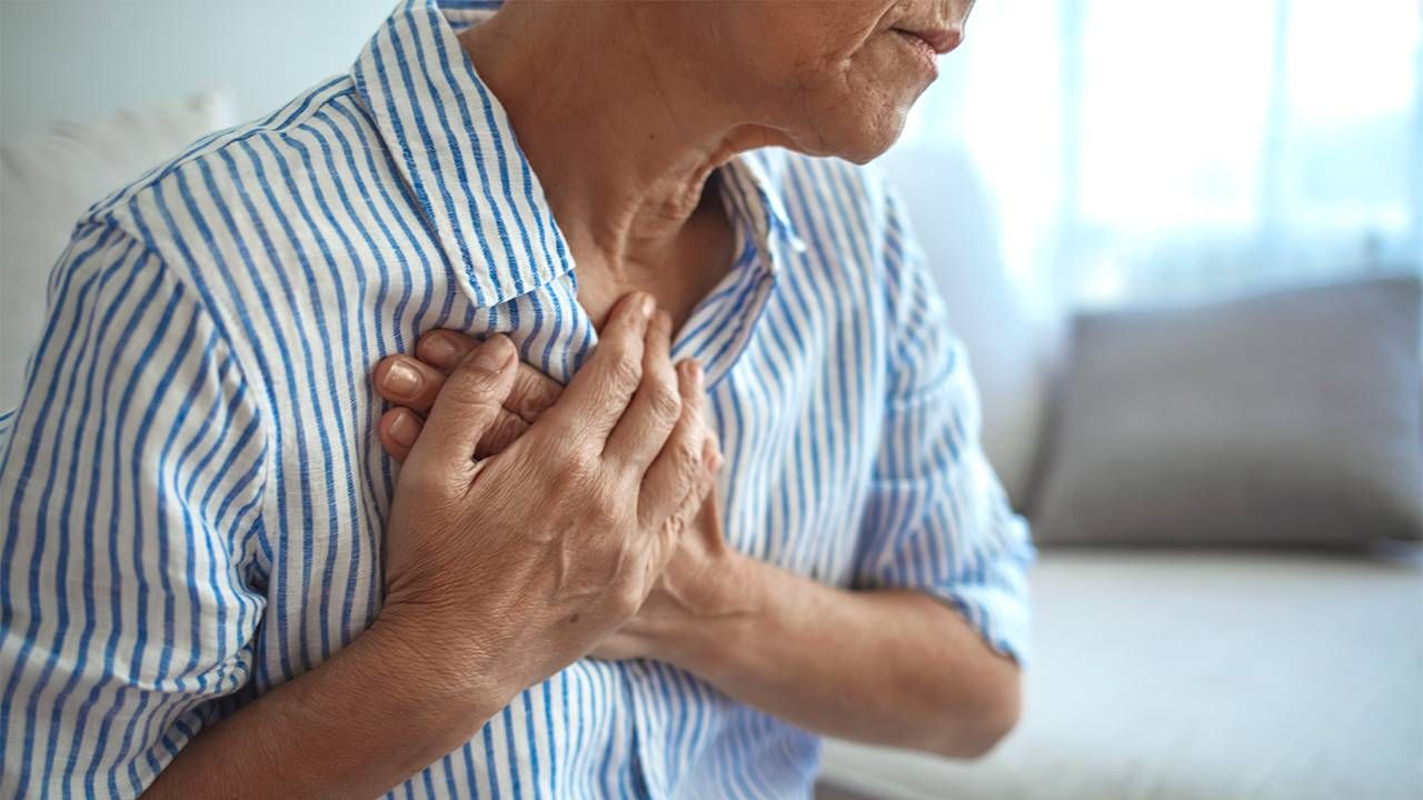 A middleaged woman grabbing her chest in pain. Ageism, heart disease, ageist, Next Avenue