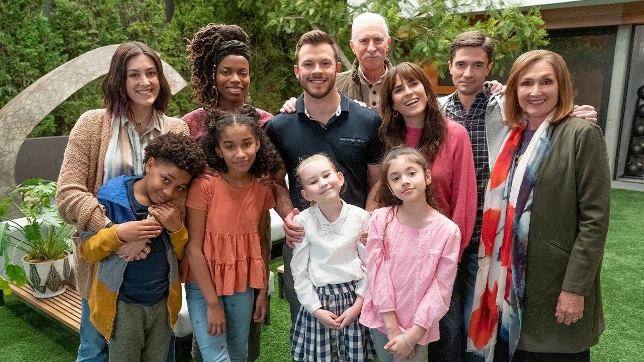 A large family smiling outside.