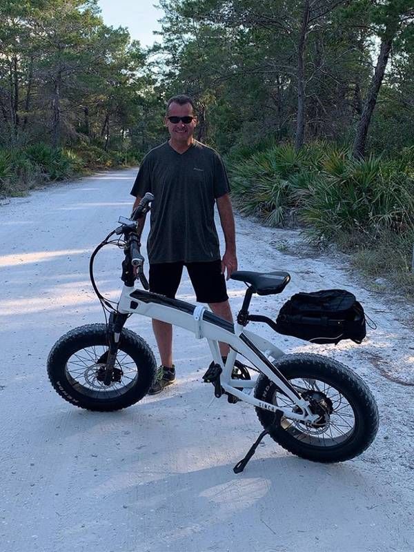 An older man standing in front of his electric bike. E bike, Next Avenue