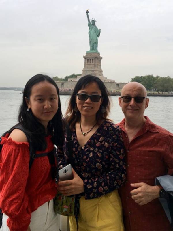 A family posing in front of the statue of liberty. Dads, dad, Next Avenue