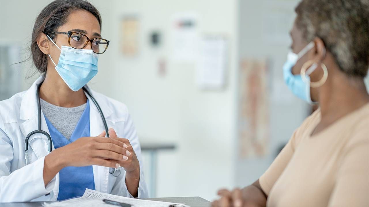 Doctor with an older patient. Dementia, Next Avenue, AARP