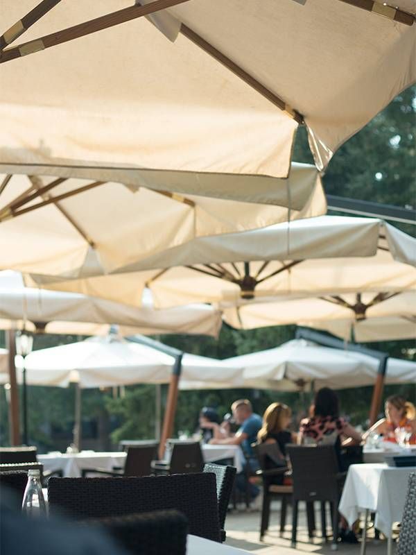 A patio covered with unbrellas. Sun exposure, Next Avenue