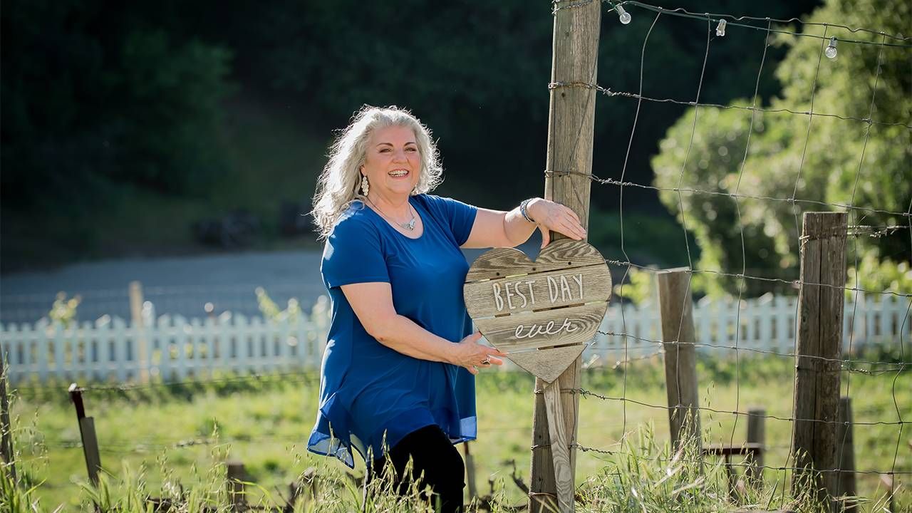 A woman standing outside near a fence. Entrepreneurs, small business, Next Avenue